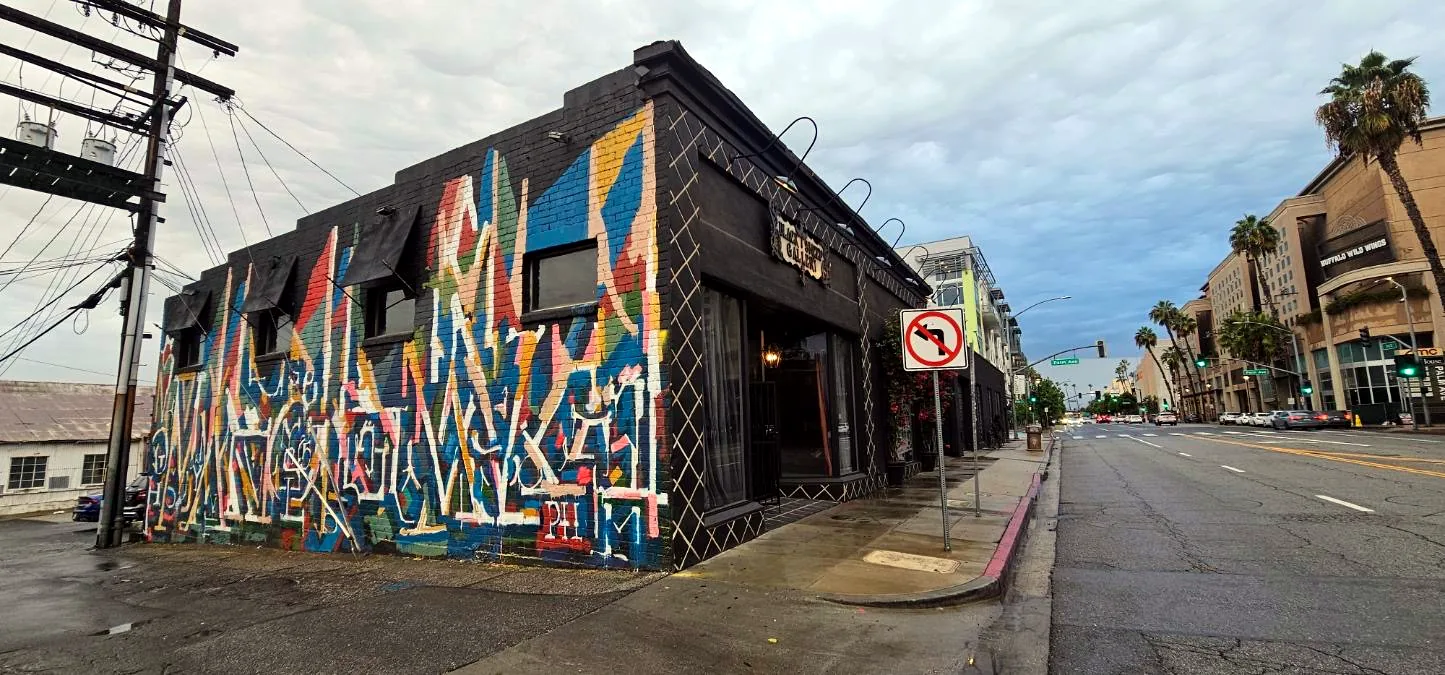 Exterior of the building with a colorful mural on the corner