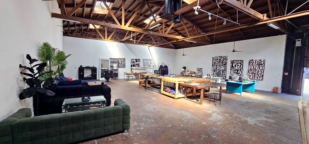 Loft lounge area with green sofa and worktables